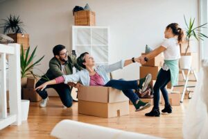 Couple comparing rental and homeownership costs at a kitchen table with documents and a calculator